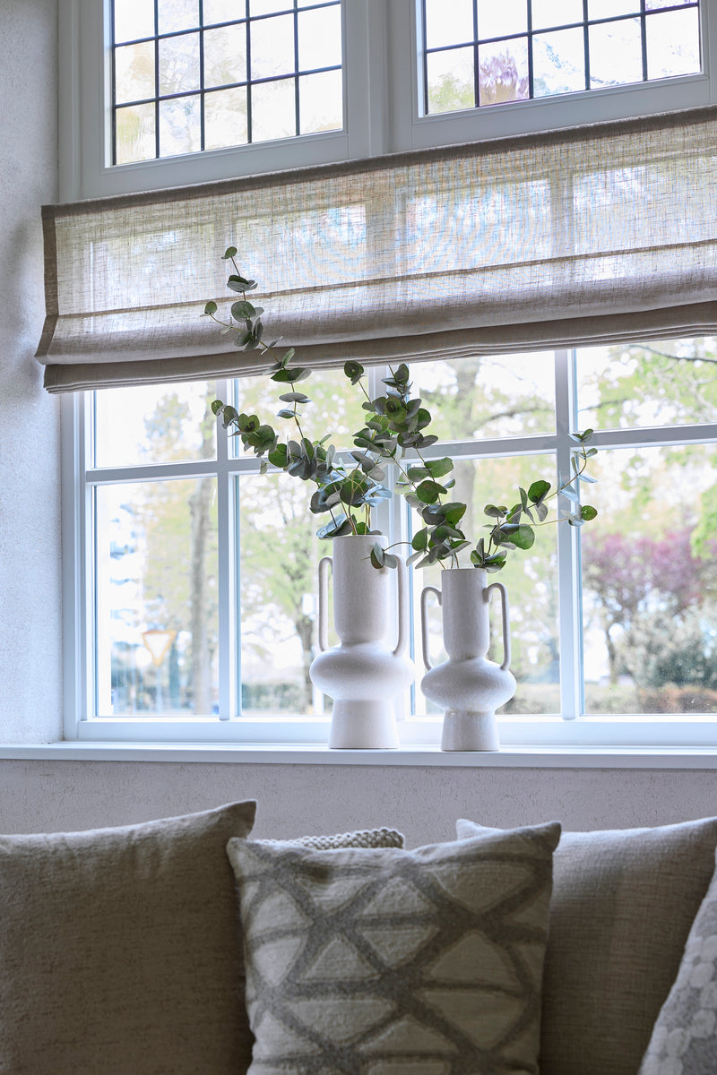 pair of cream sculptural OTARU vases styled on a windowsill with eucalyptus stems
