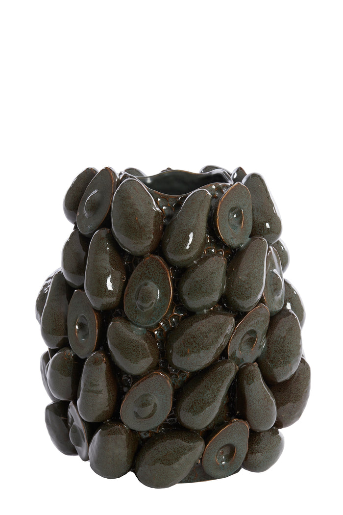 avocado vase styled on a dining table with candles and décor in a modern interior