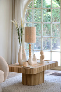 katha matt cream sculptural vase styled on wooden table with neutral decor in airy living room
