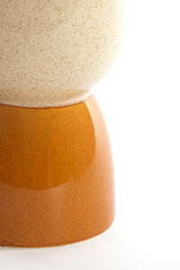 close-up of glossy ochre ceramic base of finca side table