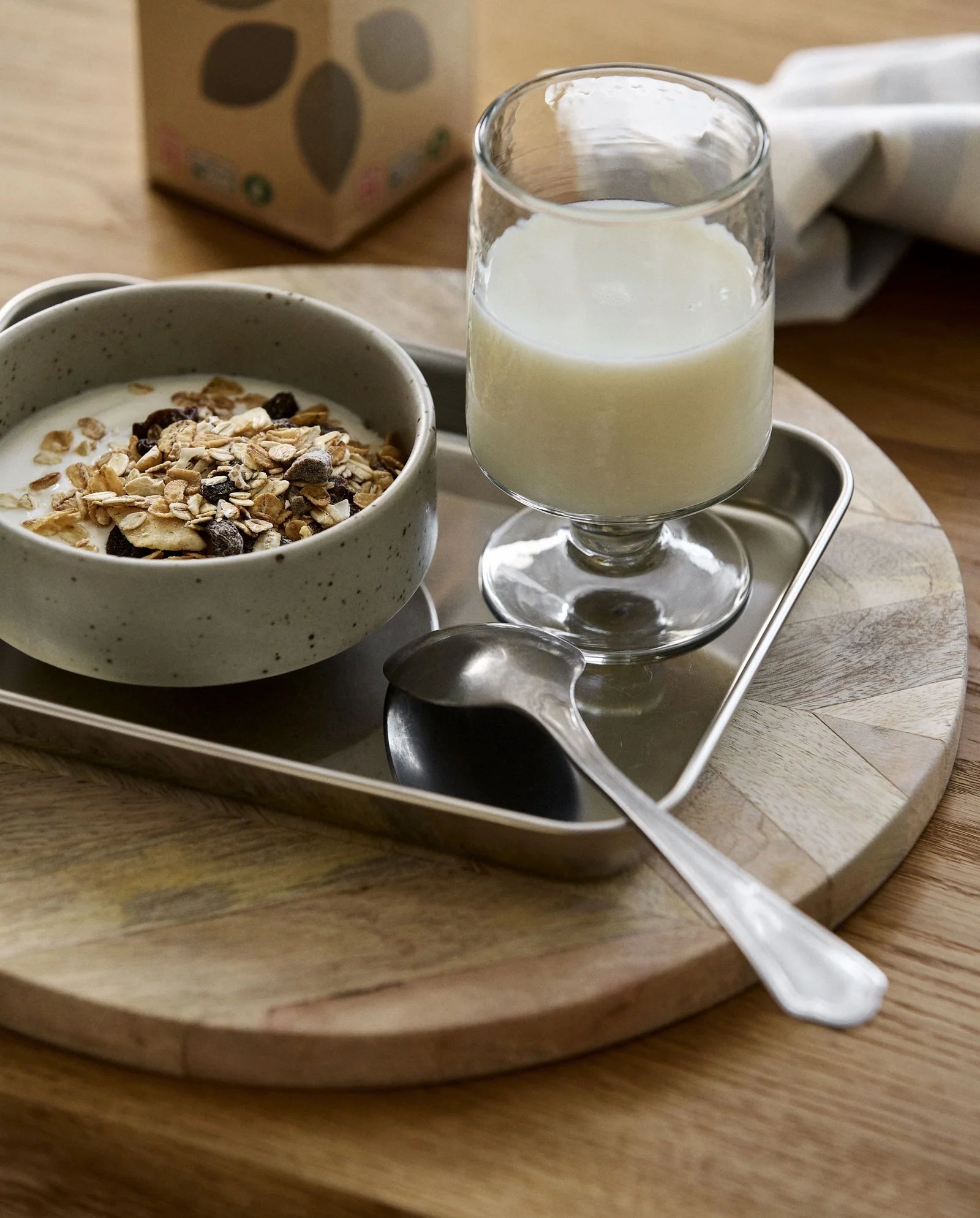 LUCIDUS chrome tray S by Nordal styled with a coffee cup, dotted plate and macadamia nuts