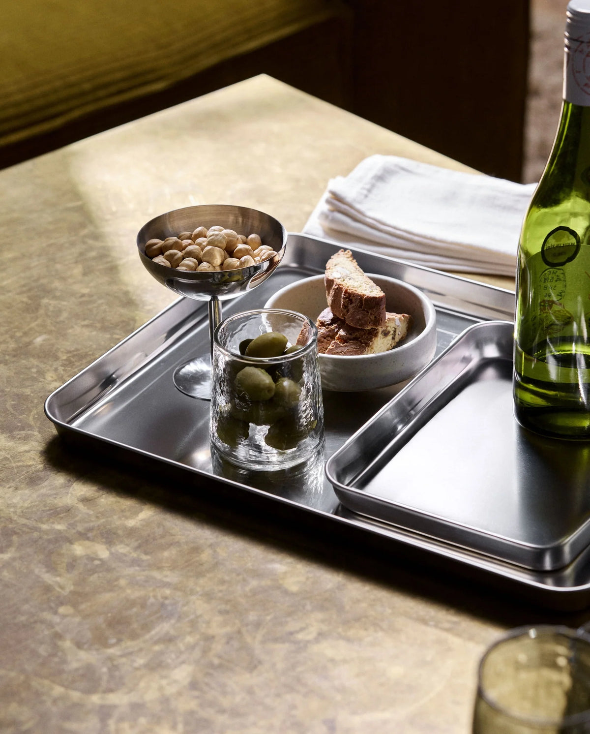 LUCIDUS chrome tray S by Nordal styled with a coffee cup and dotted plate on a wooden board