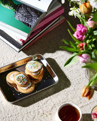 LUCIDUS chrome tray S by Nordal styled with iced sprinkle biscuits, books and tulips