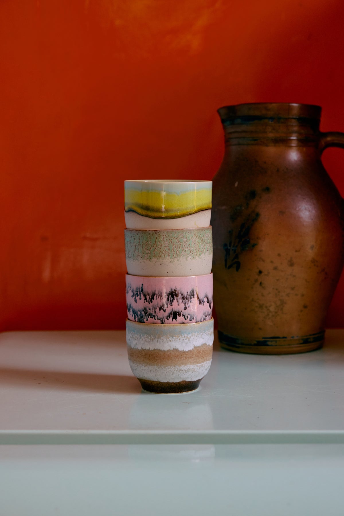 stacked 70s ceramic café cups showing hand-finished textured glazes
