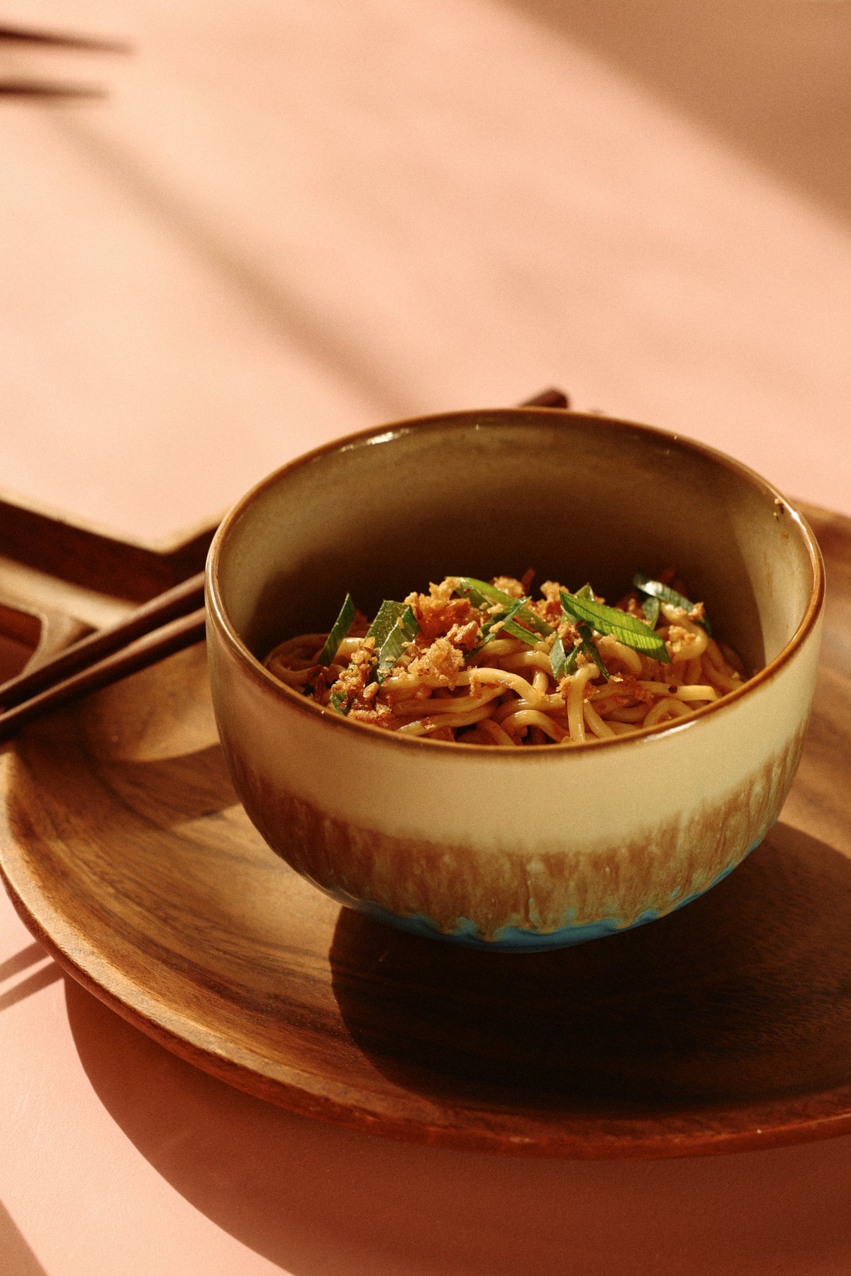 stoneware noodle bowl filled with noodles showing coastal-inspired glaze
