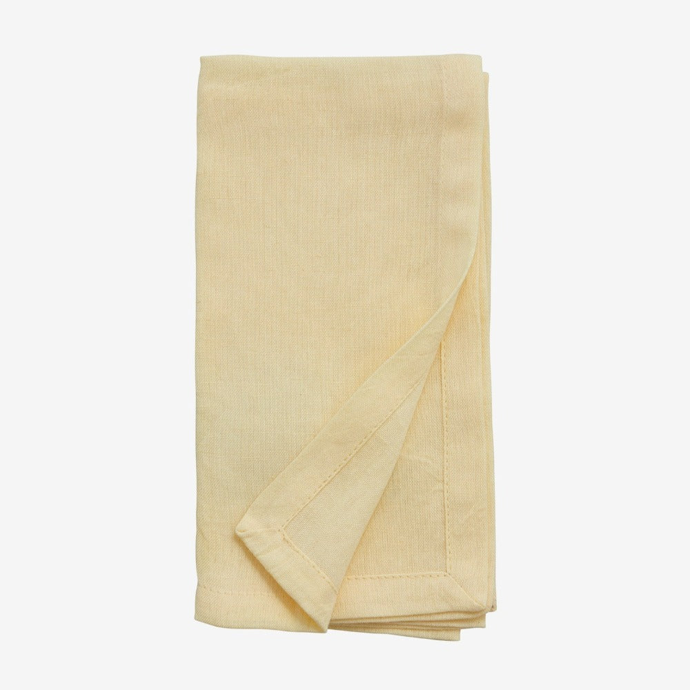 hand hemmed cloth yellow napkin folded neatly 