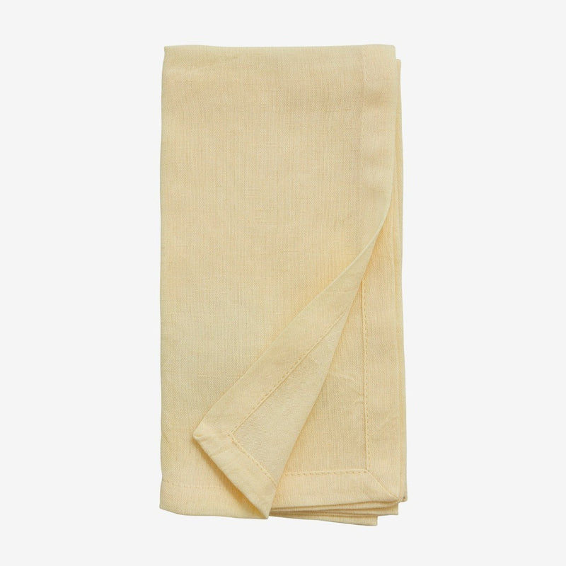 hand hemmed cloth yellow napkin folded neatly 