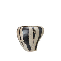 Bold ceramic planter with tapered base and expressive finish