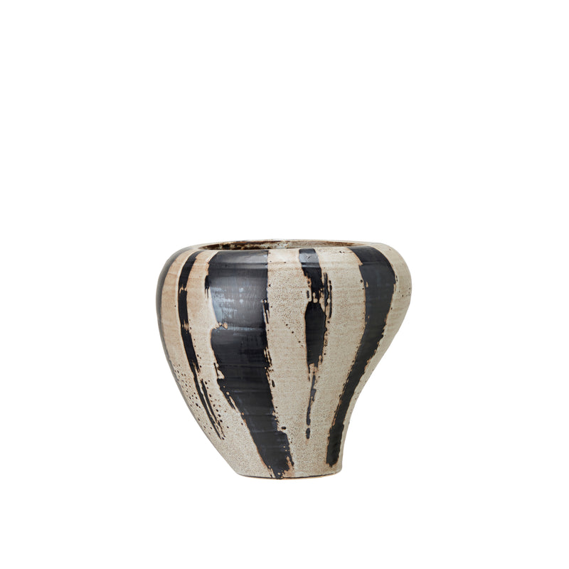 Bold ceramic planter with tapered base and expressive finish