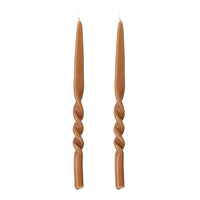 pair of brown hand-twisted taper candles by bloomingville on white background
