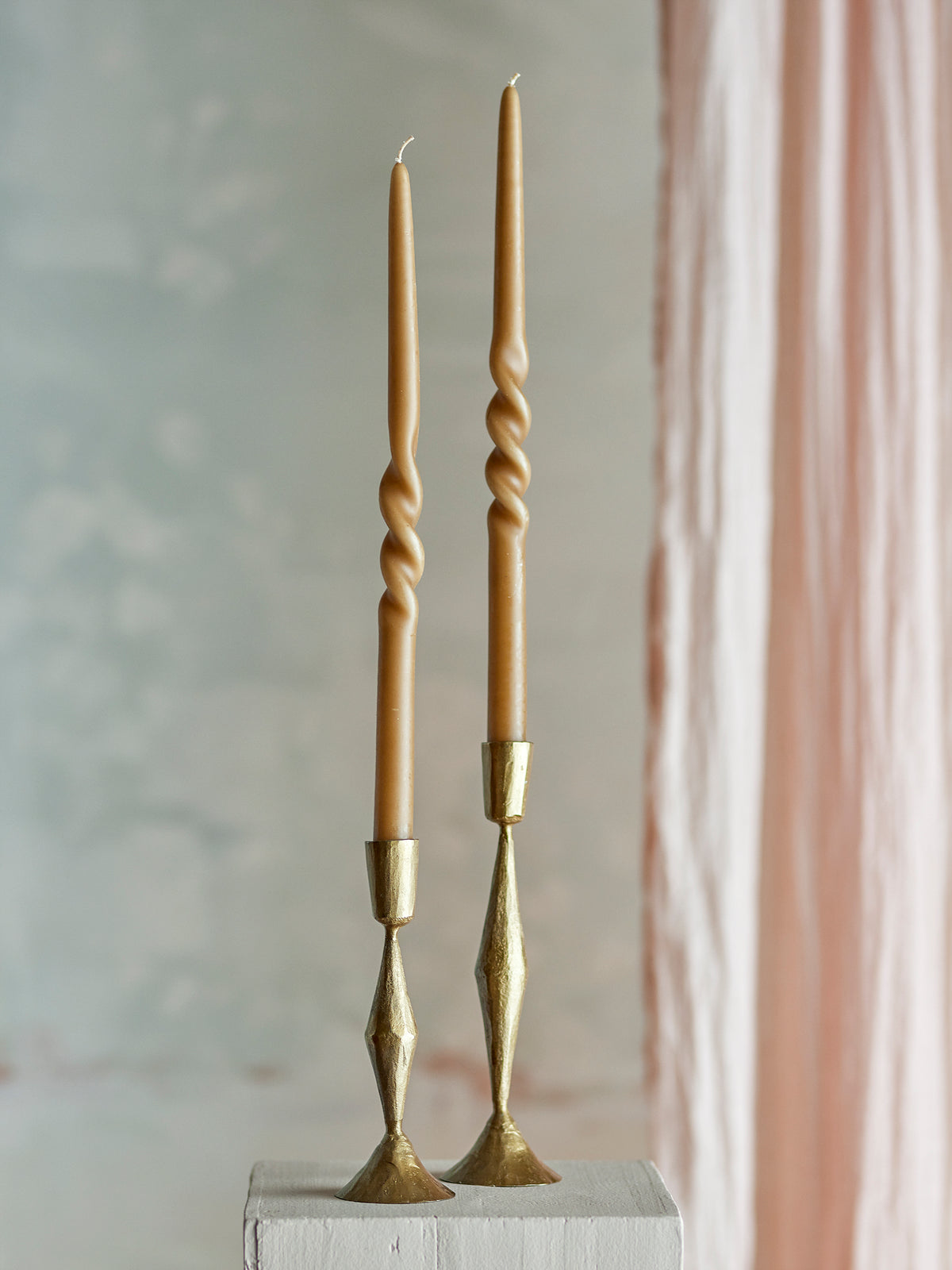 sculptural twisted taper candles in assorted colours for modern table styling
