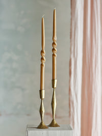 sculptural twisted taper candles in assorted colours for modern table styling
