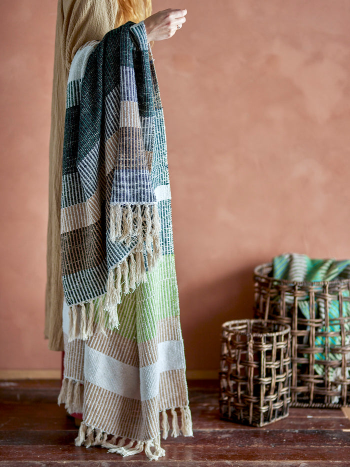 Isnel Throw – Brown by Creative Collection draped over an arm