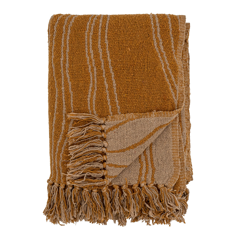 folded ginna throw in brown showing fringes and reversible wavy pattern
