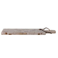 Long rectangular marble cutting board with a handle on a white background