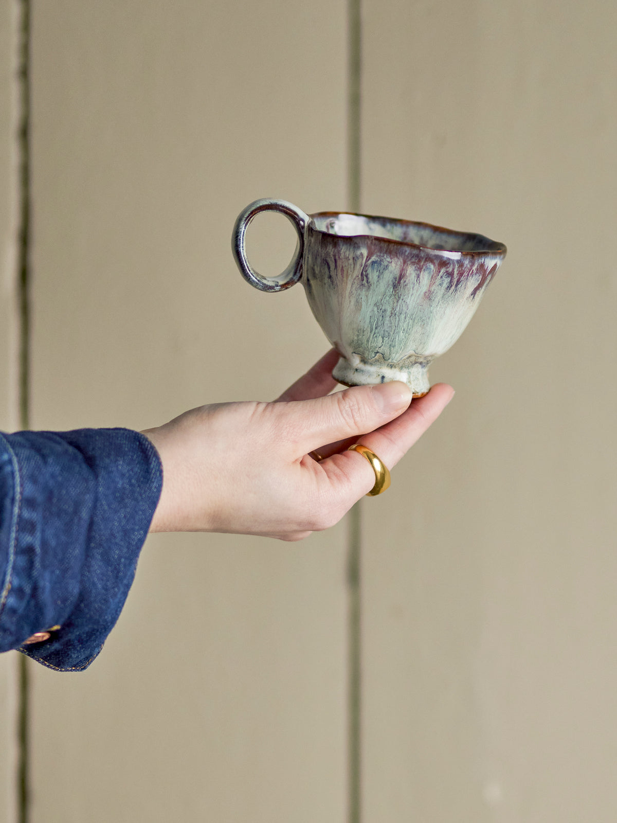 Imogen cup by Bloomingville, handmade with violet and grey glaze, held in hand
