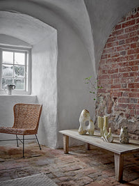 Noble beige textured stoneware vase styled on a wooden bench with other ceramics