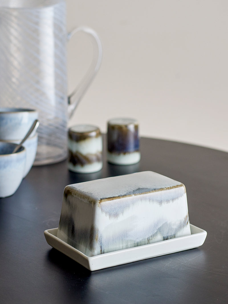 paula butter dish in grey reactive glaze styled on dark dining table
