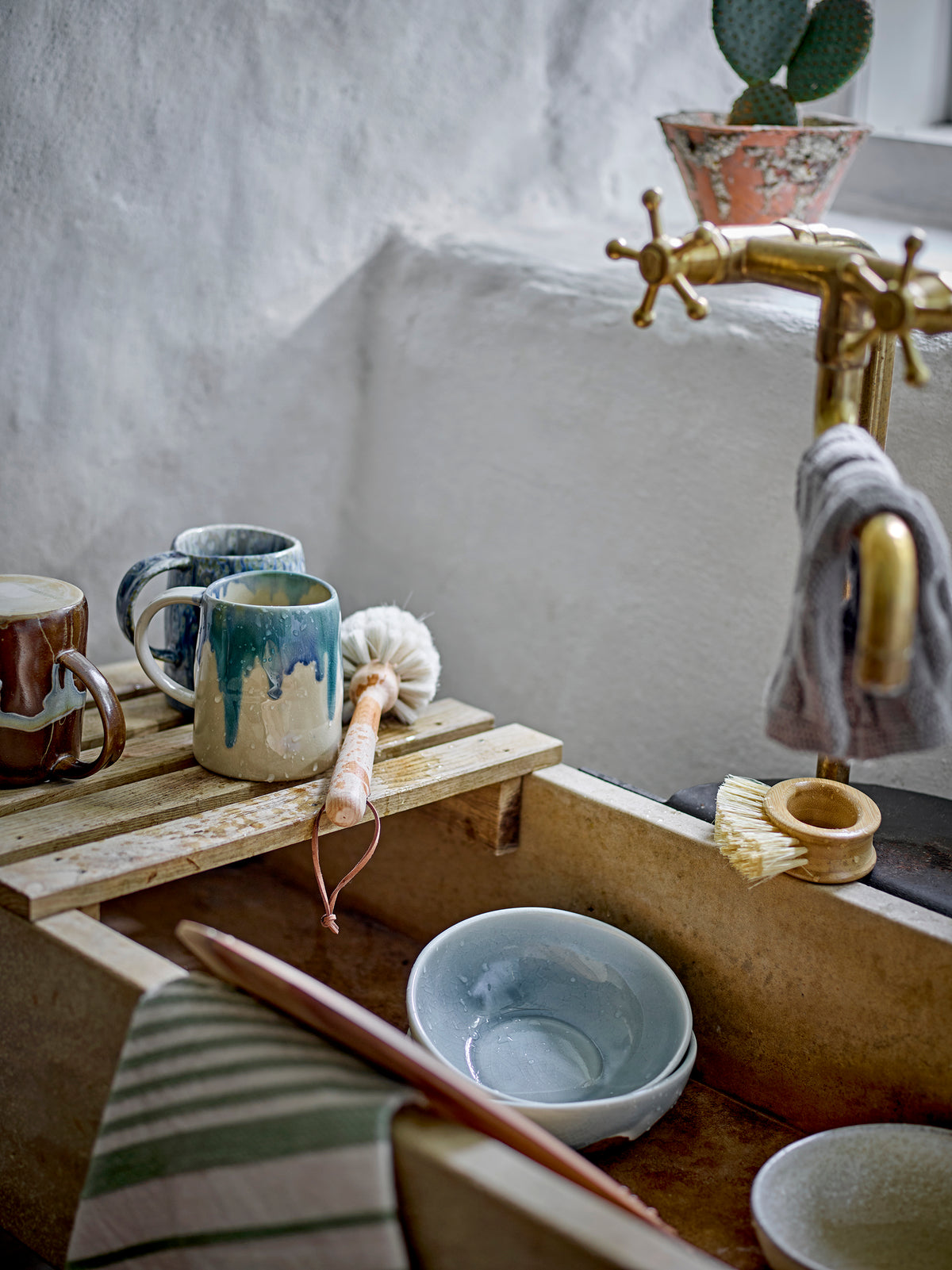 Louisa teapot in rose pink running glaze stoneware, styled on a wooden shelf with soft background, 1190ml
