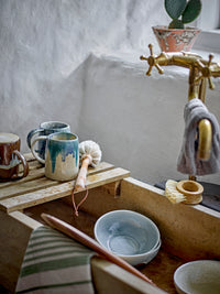 Louisa teapot in rose pink running glaze stoneware, styled on a wooden shelf with soft background, 1190ml
