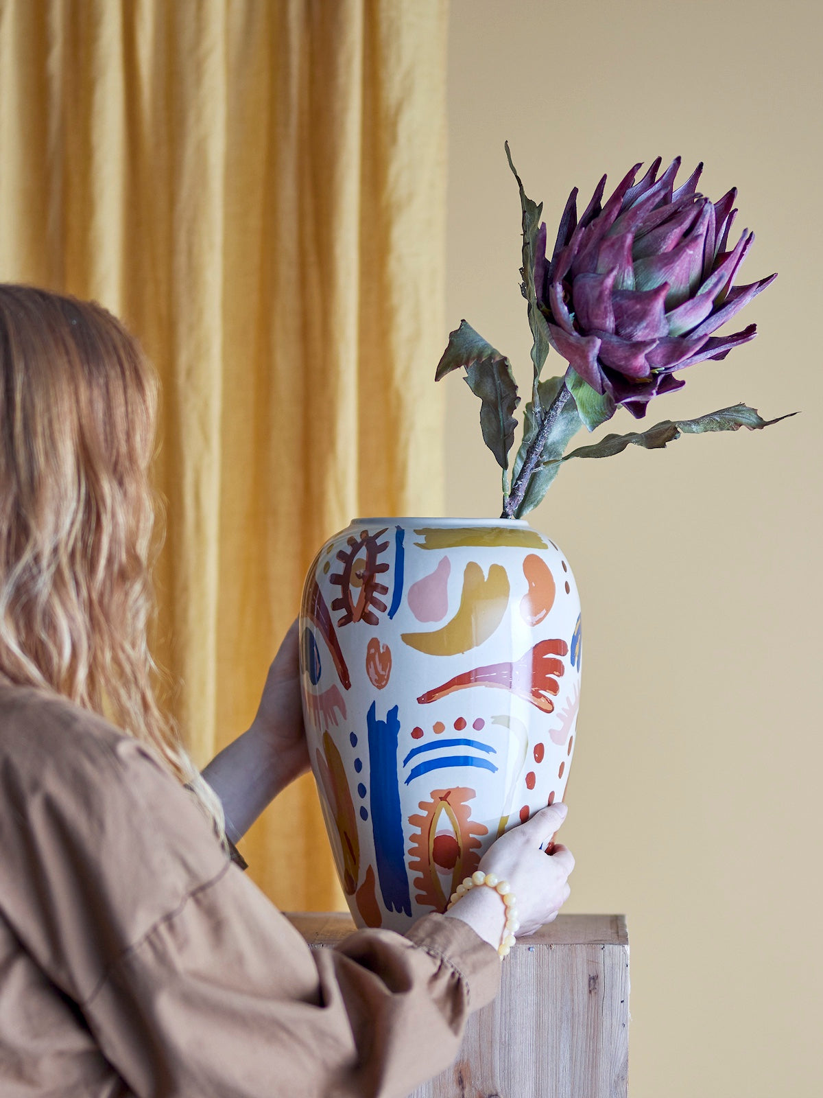 Horus multicolour vase styled on wooden chest of drawers with flowers