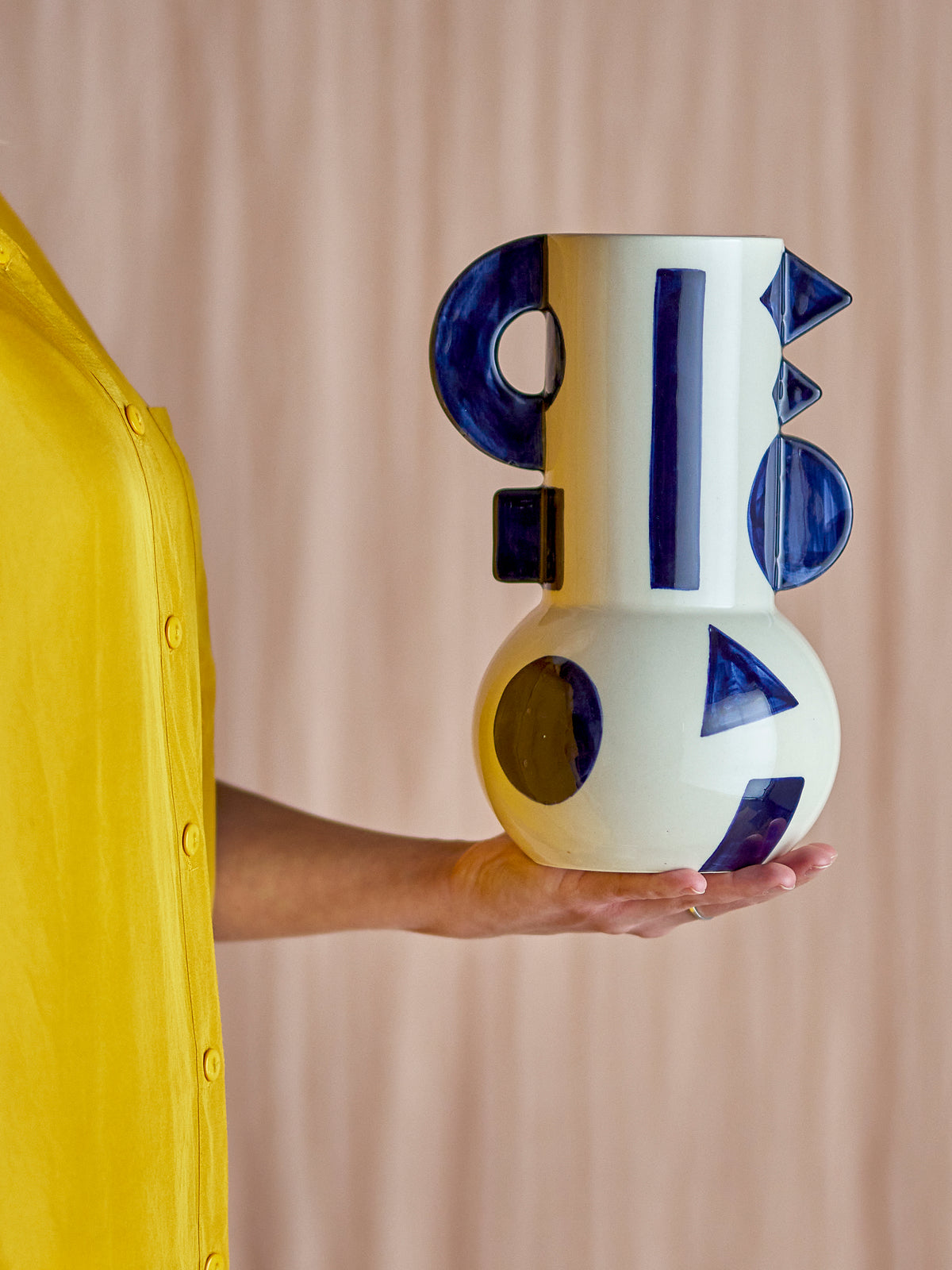 Graphica vase in blue and white stoneware, shown in hand for scale
