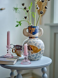 Hezha navy blue stoneware vase with bird-head handles styled with pink candlesticks
