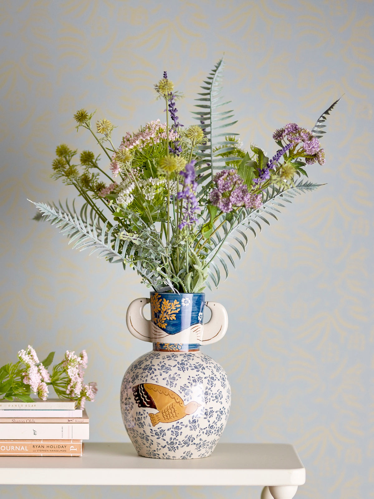 Hezha navy blue vase front view showing golden bird illustration and floral pattern