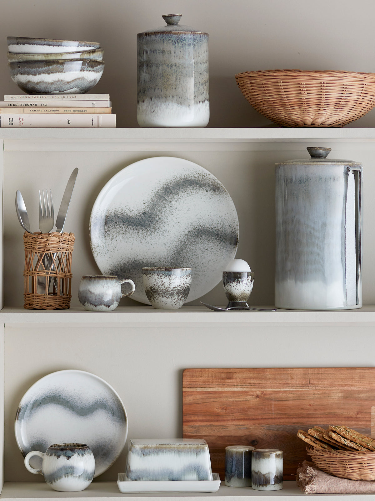 grey Paula salt and pepper shakers styled on a shelf with matching reactive-glaze Bloomingville tableware