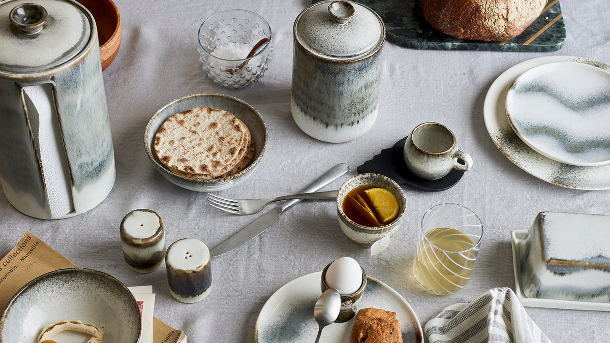 grey reactive-glaze stoneware salt and pepper shakers on a Nordic breakfast table with matching Bloomingville tableware