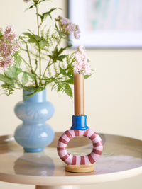 colourful tacana striped stoneware candle holder styled on a table with flowers
