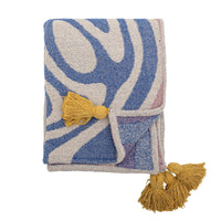 Arlie blue throw folded showing front swirl pattern and tassel detail