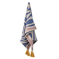 Arlie blue throw hanging showing full swirl pattern and mustard tassels