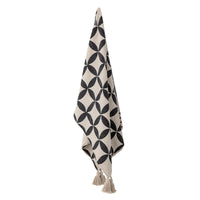 Forma throw hanging showing full geometric petal pattern and tassels