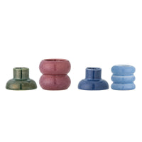 Four separate Tana stoneware candle holders in dark green, dusty pink, navy and light blue lined up on a white background