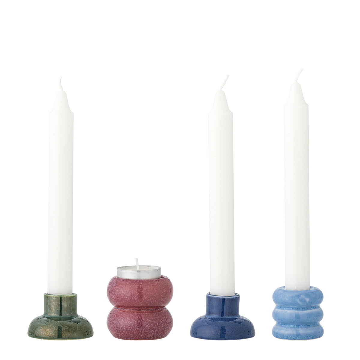 The four Tana candle holders holding three white taper candles and one tea light on a white background