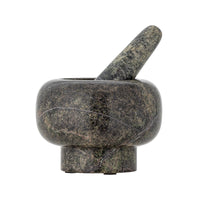 Stone mortar and pestle on a white background