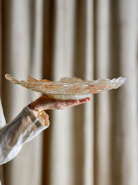 Asimi champagne gold glass bowl held in hand showing rippled edge profile