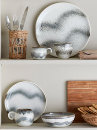 grey paula cup by bloom­ingville displayed on shelf with reactive glaze plates