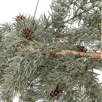Close-up of the Cedar wreath's frosted green needles, brown pine cones and woven ring