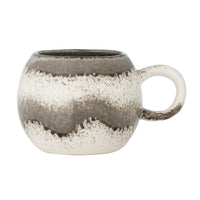 Paula grey stoneware mug with speckled cream reactive glaze and a rounded handle on a white background