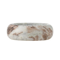Angled side view of the Indah marble bowl showing the polished swirling veining