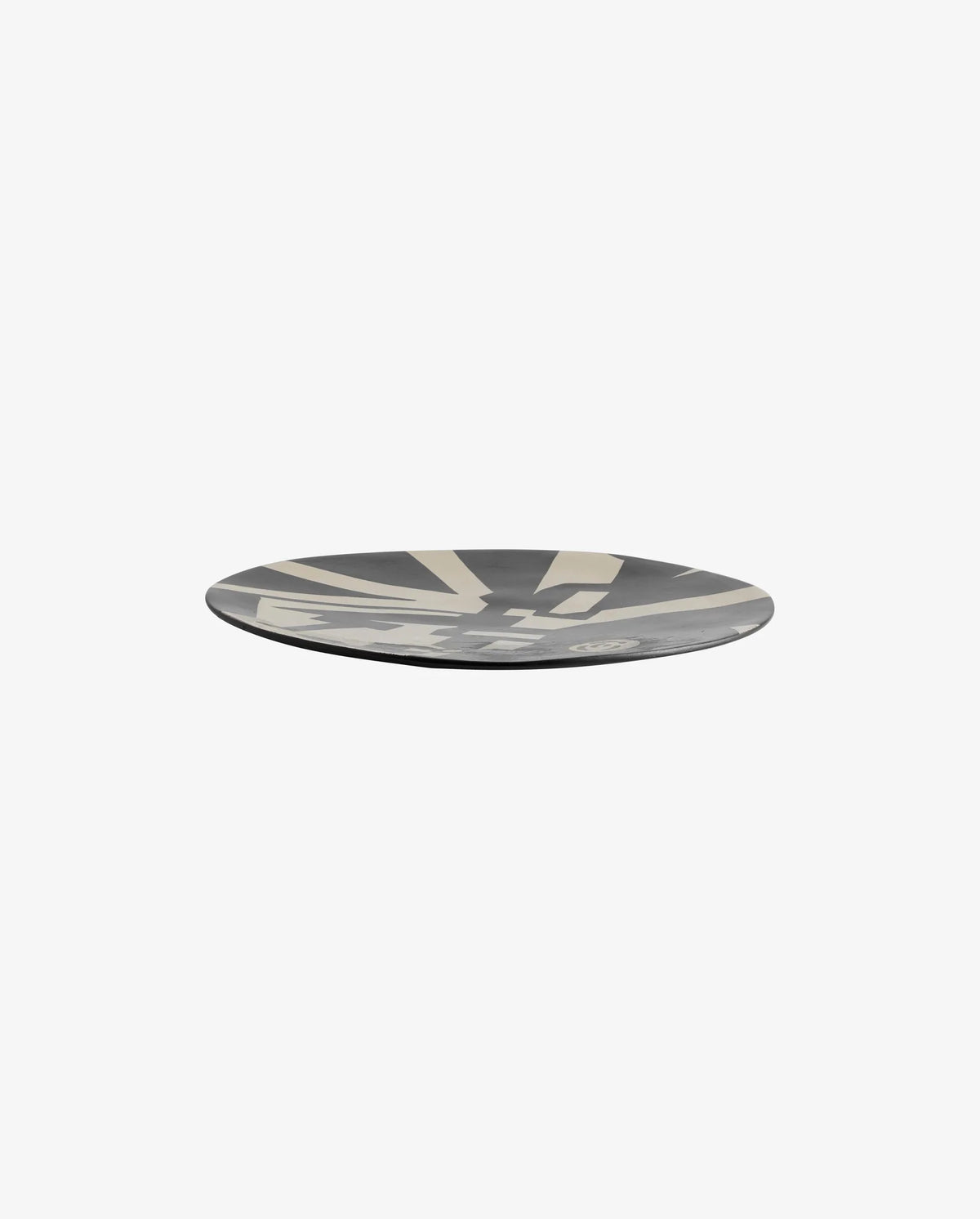 two black and beige LIPSI decorative plates by Nordal styled on a distressed concrete surface with a black and beige lidded box, a black bowl, twigs, a ball of twine and dried grasses