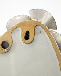 Detail of the back of the House Doctor Fold ceramic wall art showing the keyhole mounting holes and the raw unglazed stoneware edges