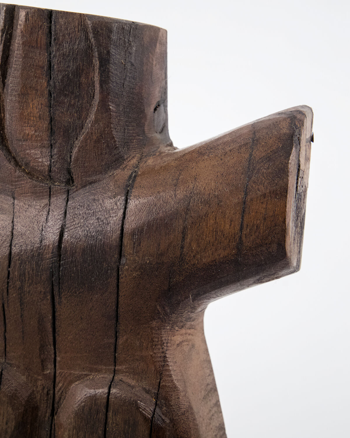 Close-up of the carved shoulder and outstretched arm of the House Doctor Human wood wall art, showing the dark espresso stain and natural mango wood grain