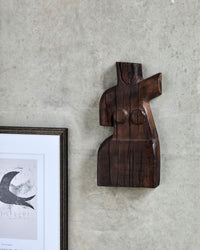 House Doctor Human wall art styled on a plaster wall beside a framed graphic print, a sculptural female figure piece for a curated modern gallery wall