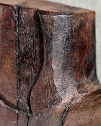 Extreme close-up of the carved mango wood and dark espresso black stain on the House Doctor Human wall art, showing the natural grain and rustic character
