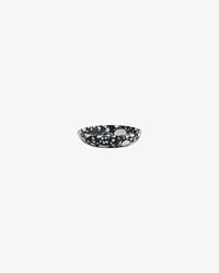 single black and white speckled terrazzo bowl on a white background, shallow round shape