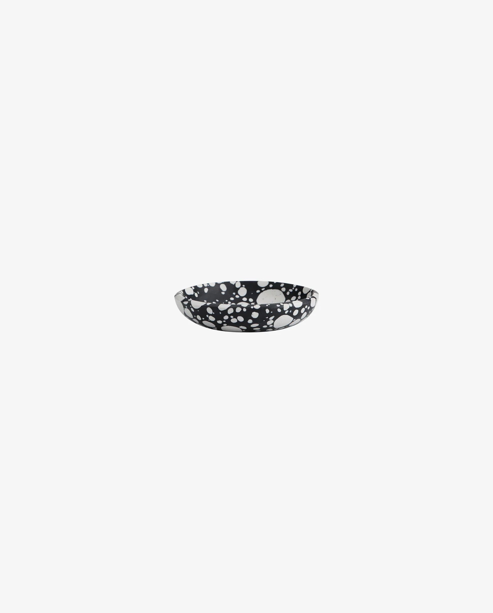 single black and white speckled terrazzo bowl on a white background, shallow round shape