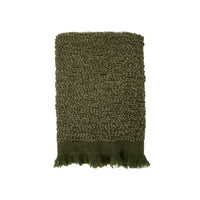 Deep green sofa throw with subtle fringe